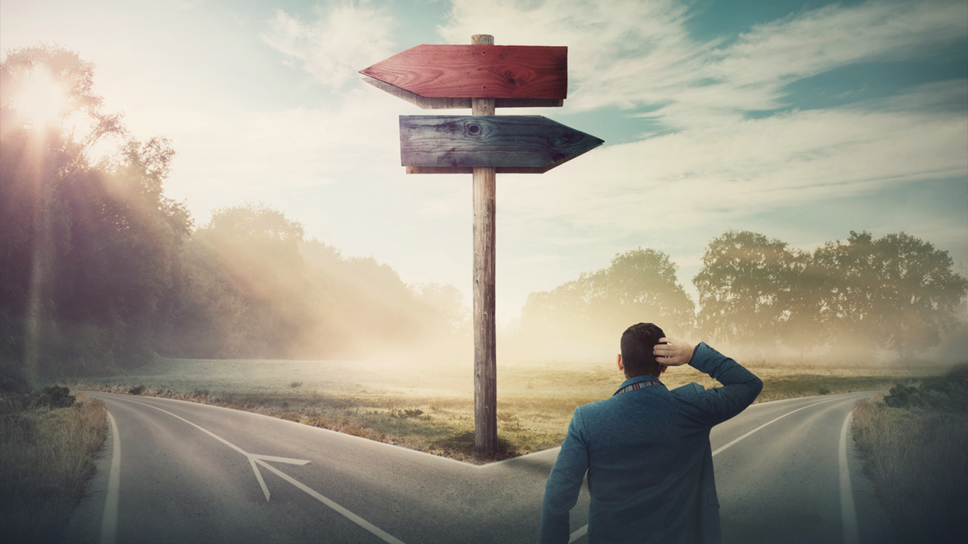 A man standing at a crossroads, symbolising decision-making in agentic data management and shifting left strategies.